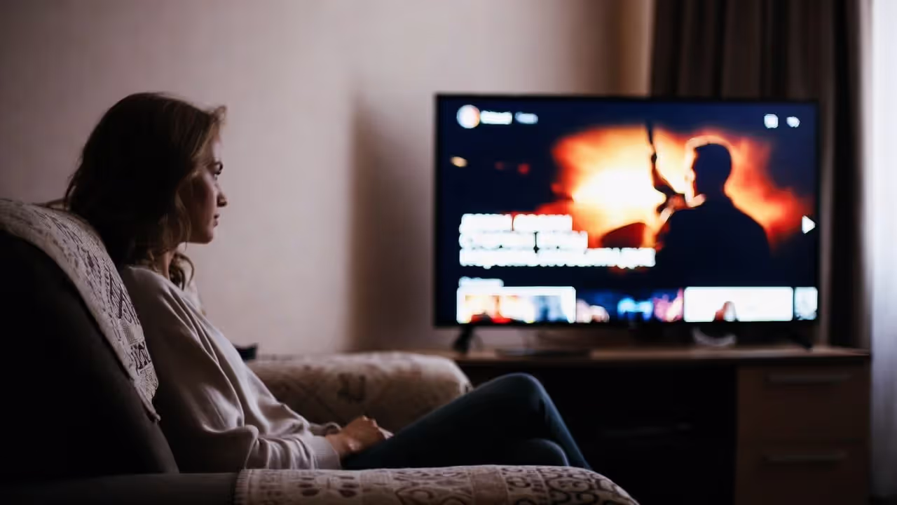 человек сидит на диване и смотрит русские сериалы про маньяков